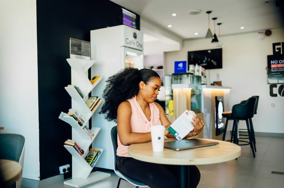 woman reading book in cafe