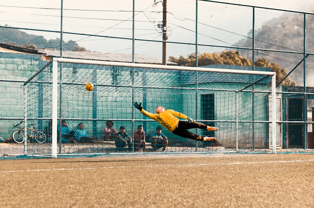 man playing soccer in field