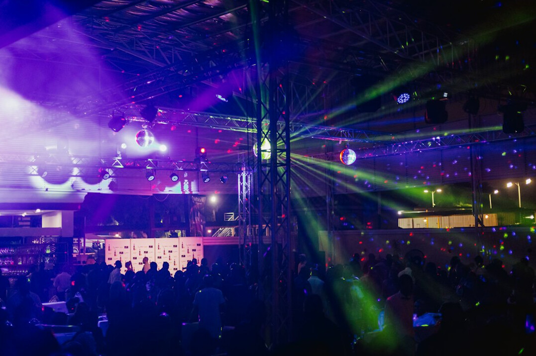 Concert stage with colorful lights and cheering crowd